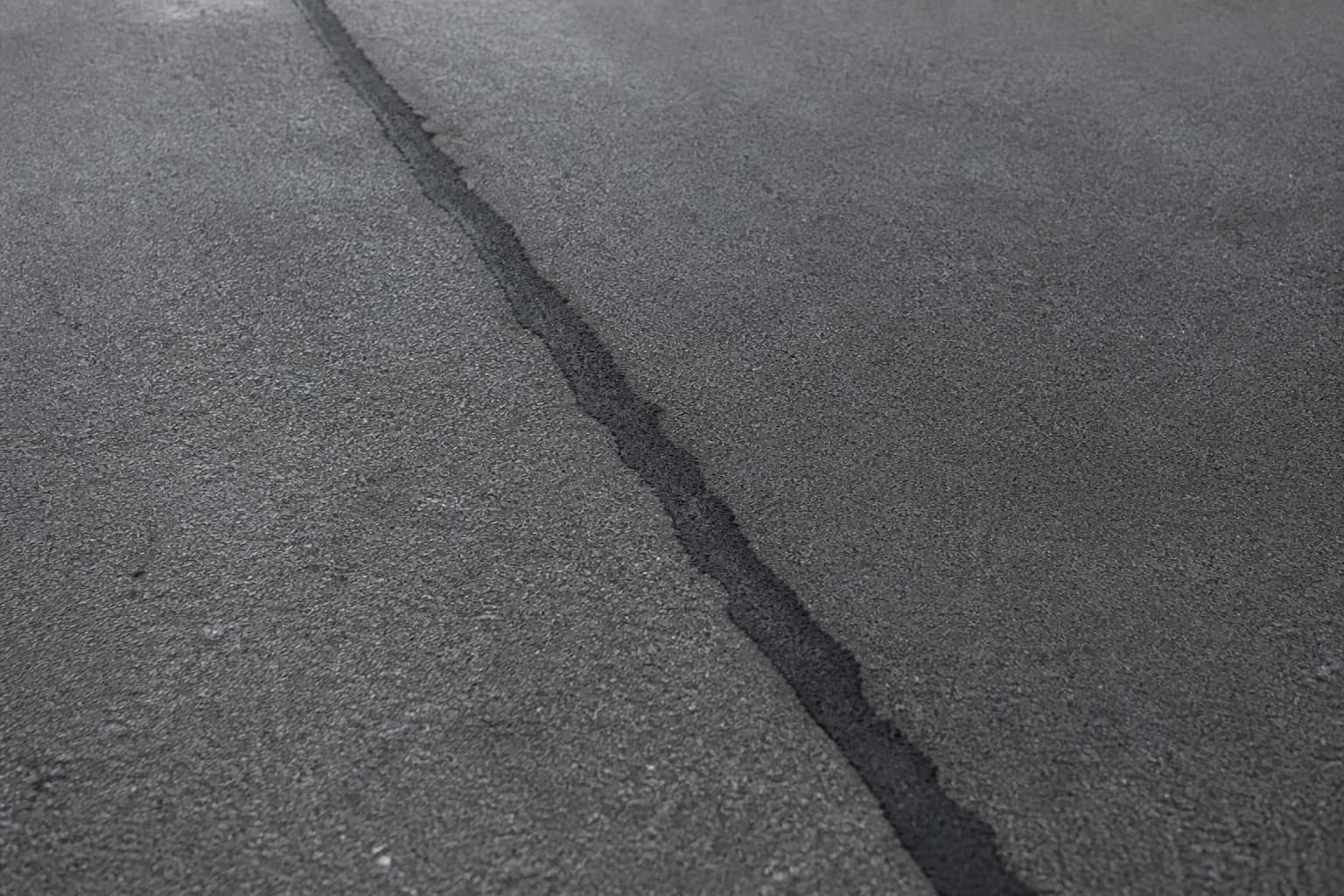 Close-up of seamless asphalt repair with smooth resurfaced texture